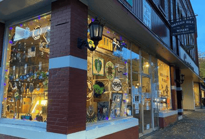Store front with Stained glass art hanging in the window
