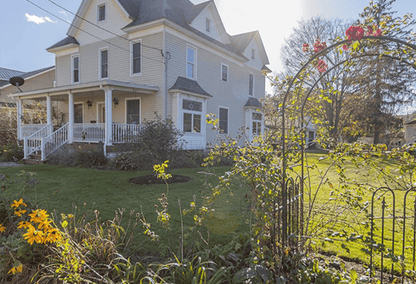 White house with flower garden in the foreground